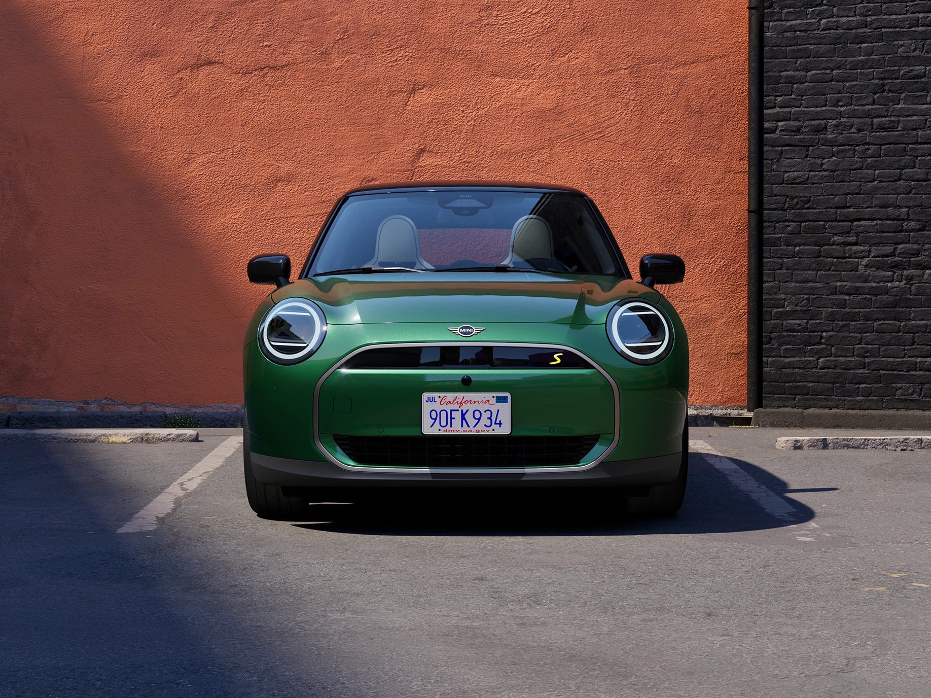 Front view of an all-electric MINI Cooper in British Racing Green and Black Roof.