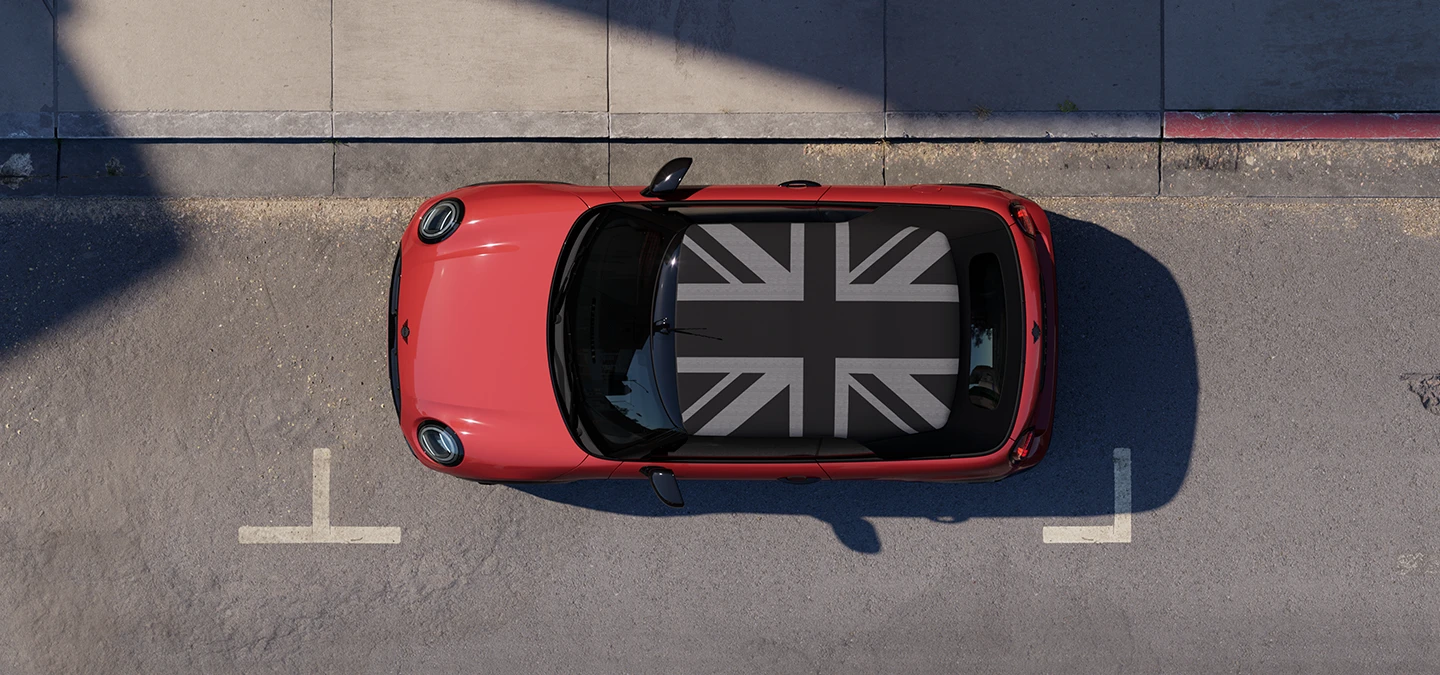 Top view of the MINI Cooper Convertible in Chili Red and MINI Yours Roof standing on a street.