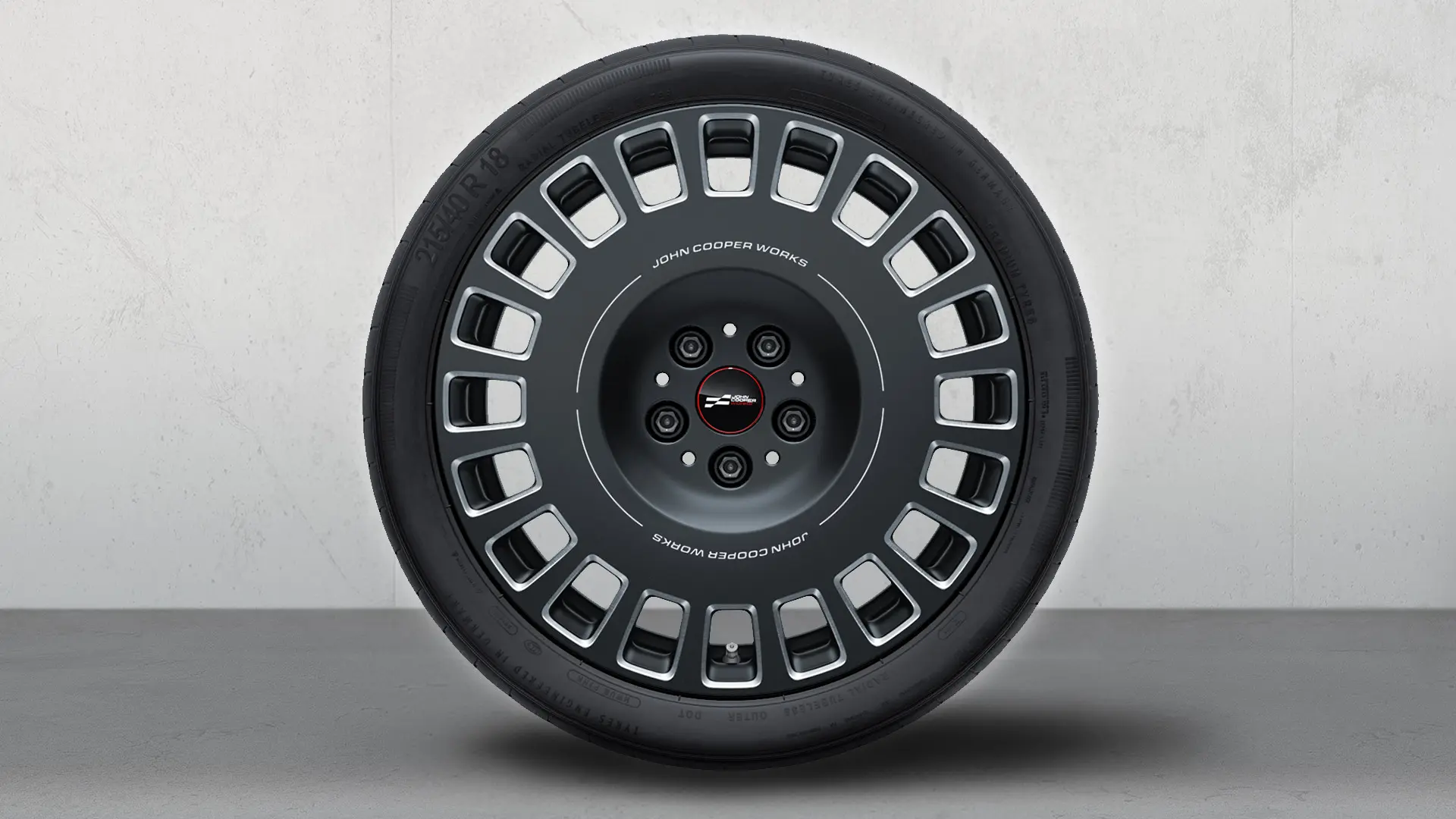 MINI JCW 18" Rallye Spoke 964 wheel in Frozen Midnight Grey and diamond-milled finish.