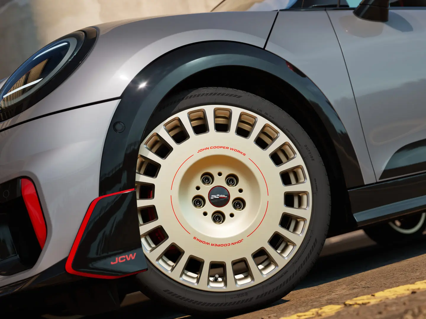 Close-up of the details on a 18" JCW Rallye Spoke 964 wheel in Bicolour Vibrant Silver and diamond-milled and front winglet.