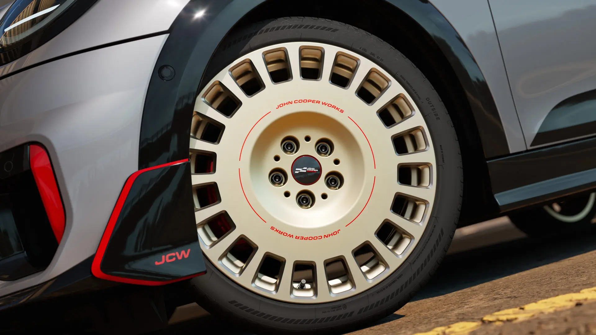 Close-up of the details on a 18" JCW Rallye Spoke 964 wheel in Bicolour Vibrant Silver and diamond-milled and front winglet.