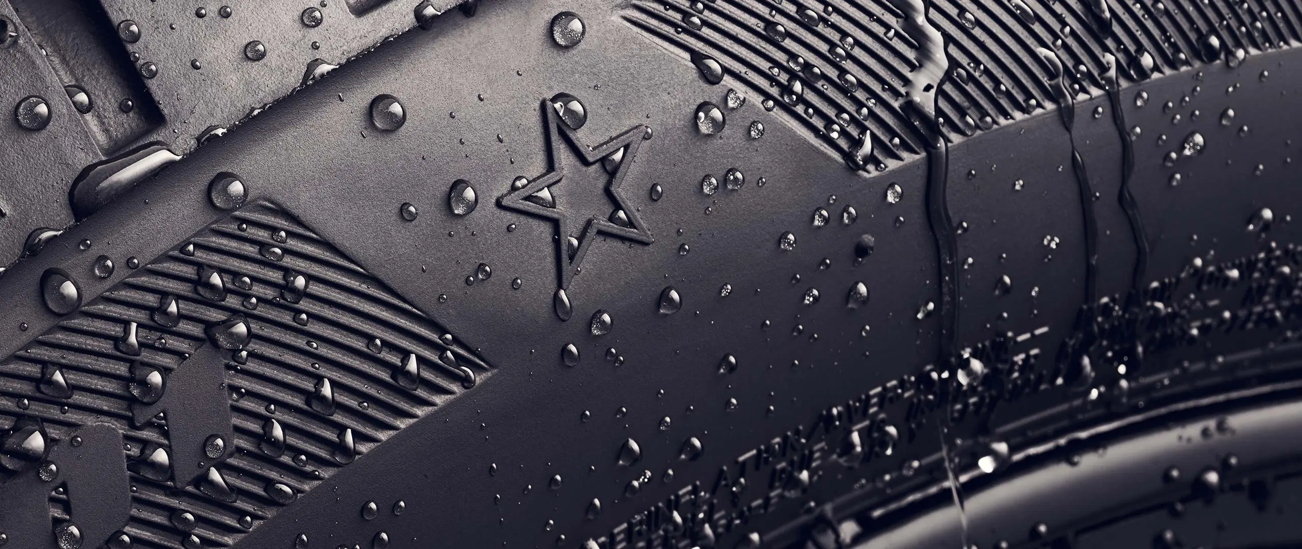 Close-up of a tyre sidewall showing the star symbol, which indicates it is approved for optimal performance on MINI vehicles. 