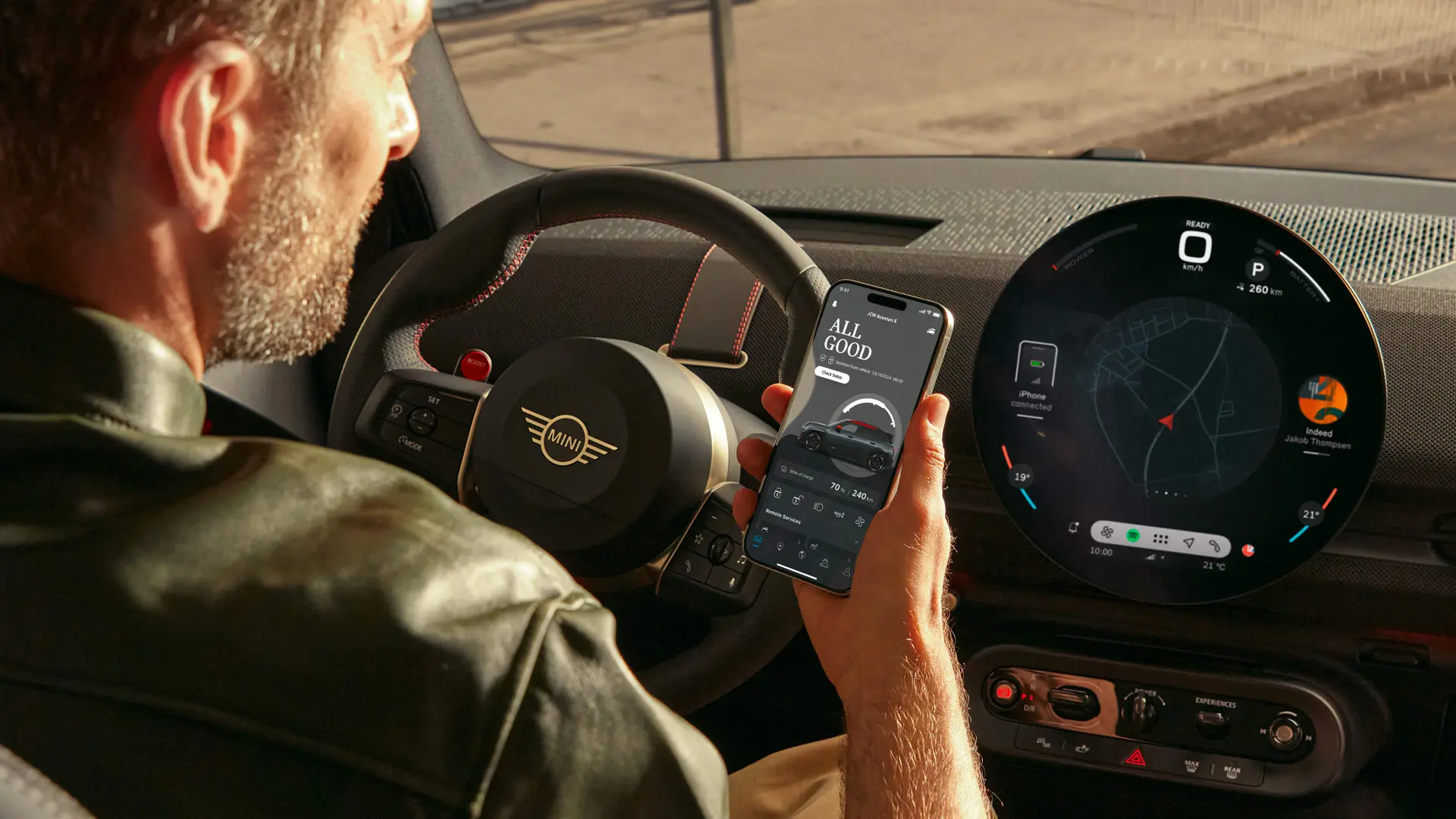 MINI driver using MINI App in his phone for navigation services.