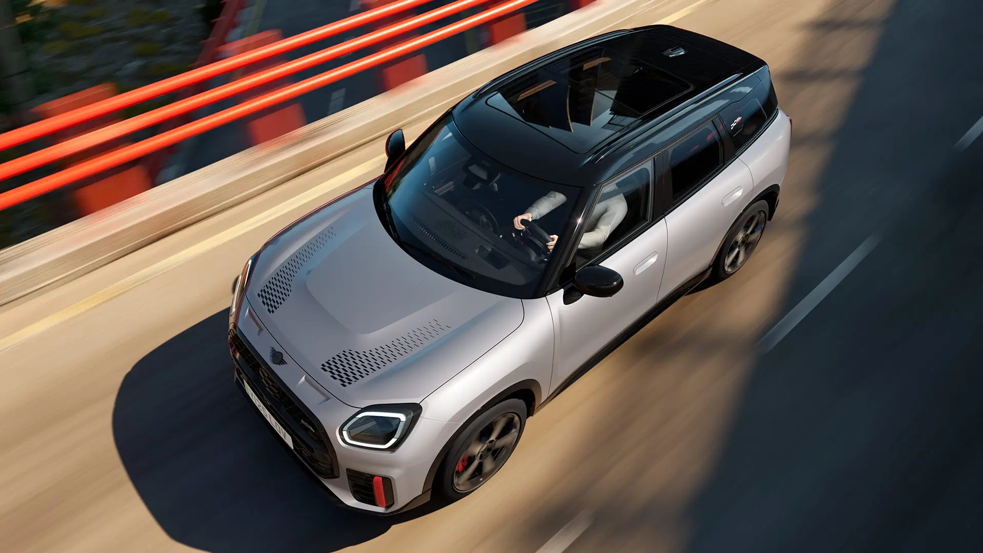 MINI Countryman John Cooper Works in Melting Silver with black roof showing standard equipment – front side view.