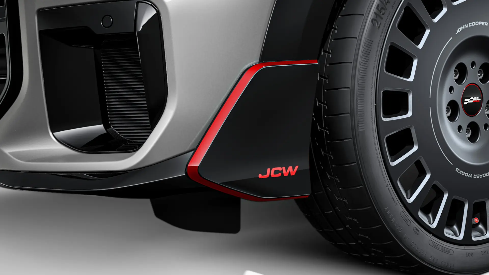 MINI John Cooper Works front winglet in black-high gloss with red JCW lettering and accent stripes.