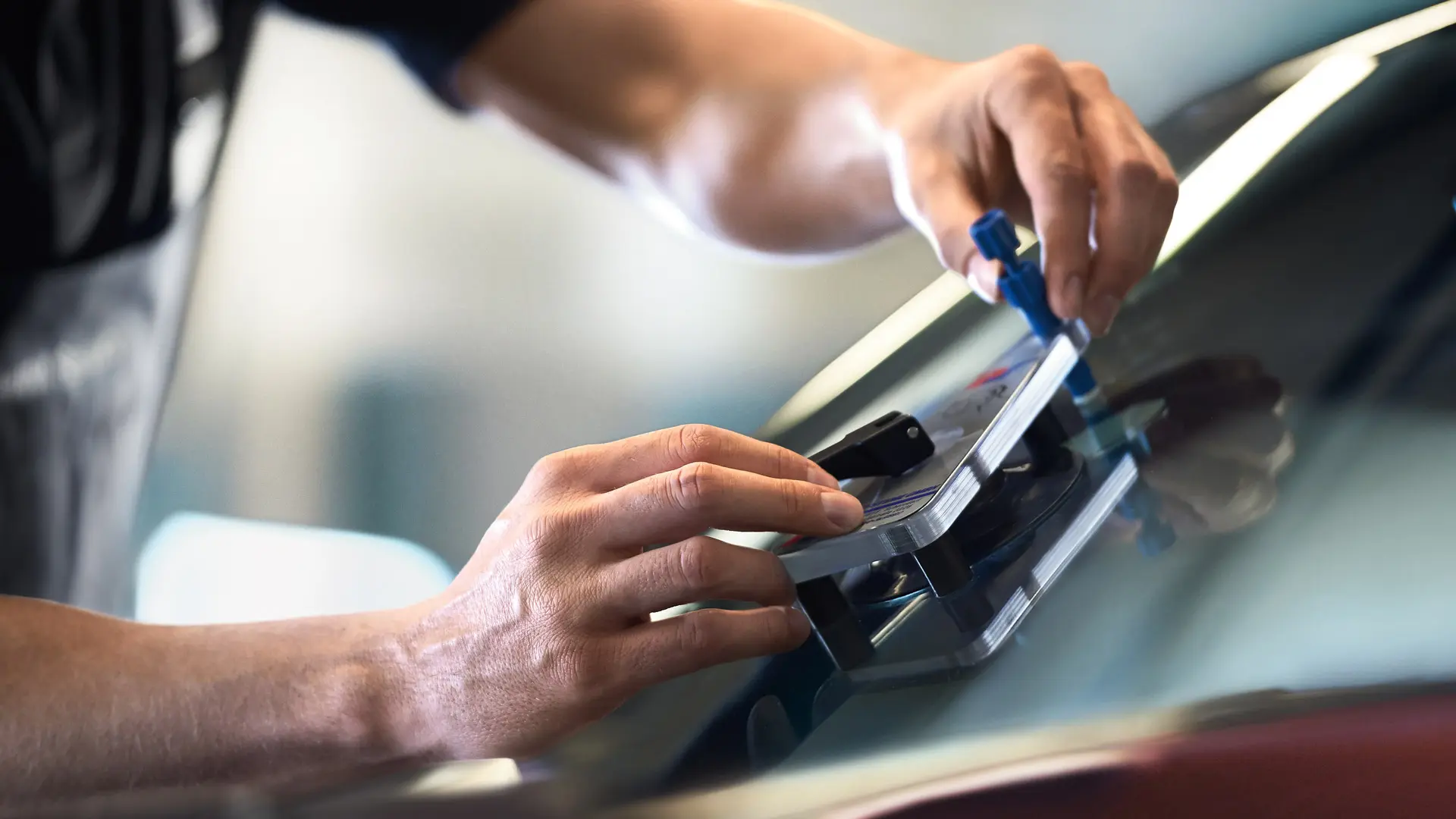MINI employee repairing glass