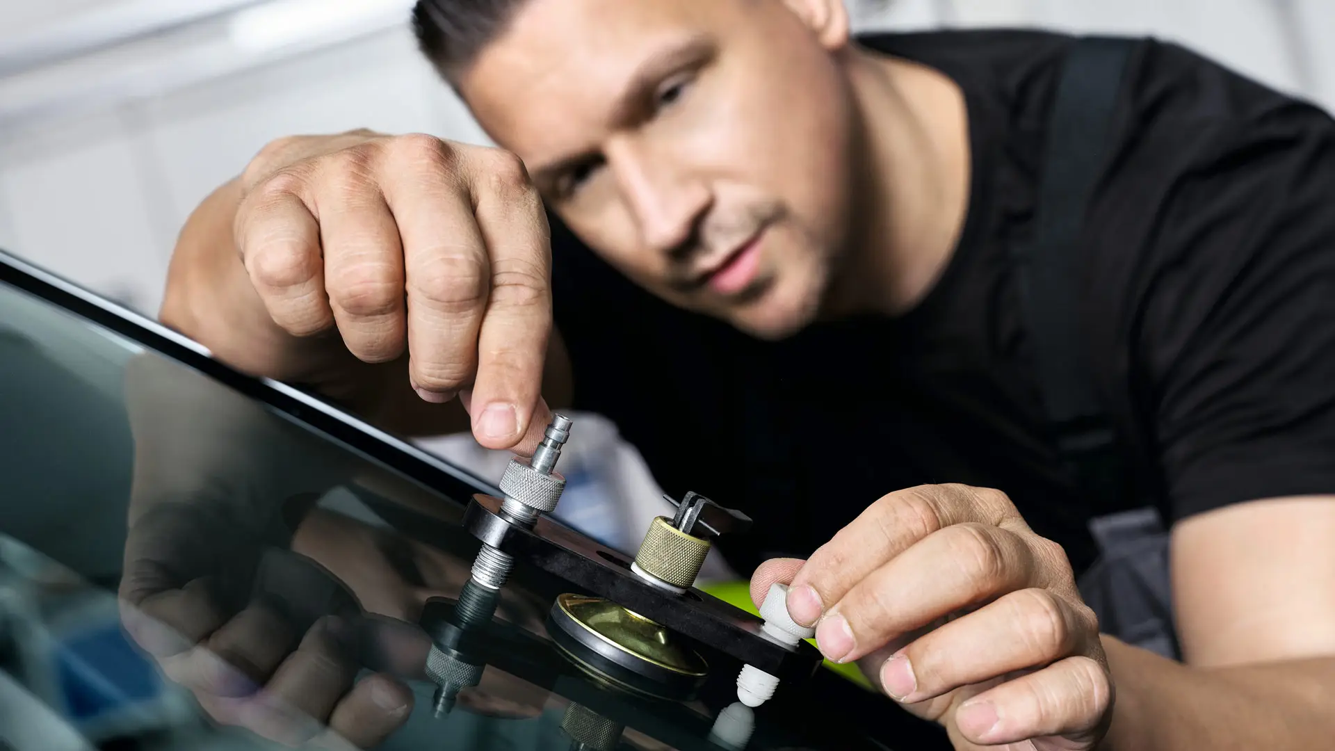 MINI employee repairs windshield.