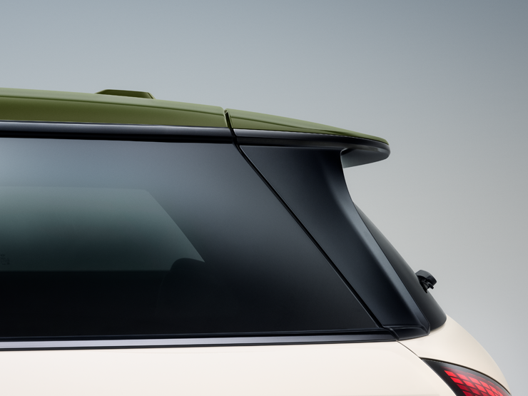 Front side view of the all-electric MINI Cooper Paul Smith Edition in Inspired White and contrast roof in Nottingham Green.
